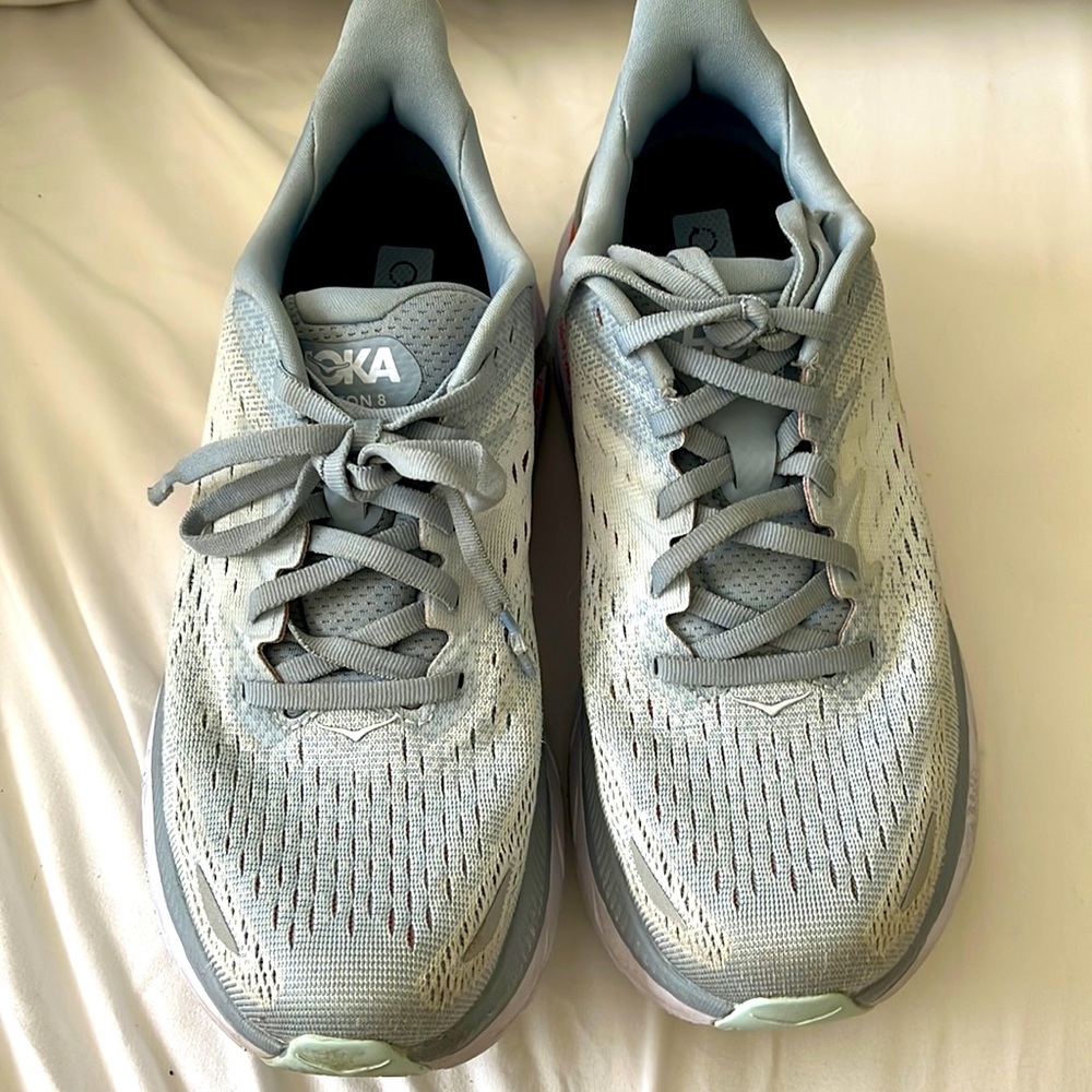 Hoka Woman’s Clifton size 8 light blue with orange on soul excellent condition